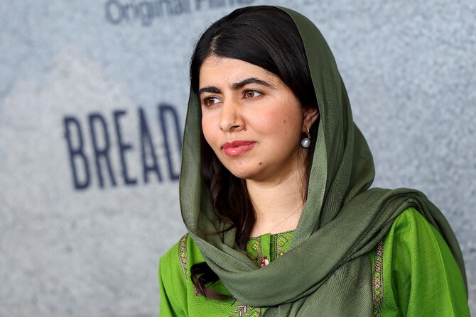 Malala Yousafzai, Nobel Peace Prize winner and education activist, smiling confidently in a traditional headscarf.